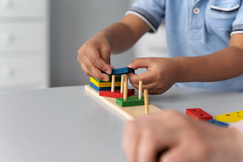 Child stacking colorful wooden blocks during fine motor skills play